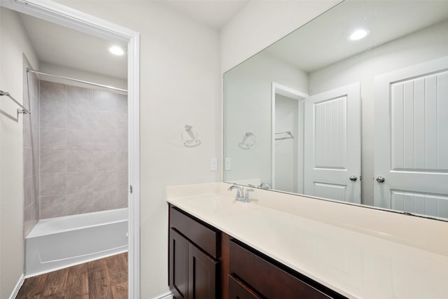 bathroom featuring hardwood / wood-style flooring, bathing tub / shower combination, and vanity