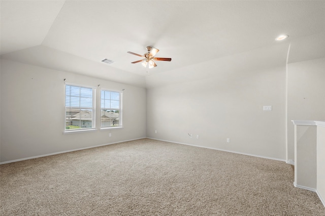 carpeted empty room with ceiling fan and vaulted ceiling