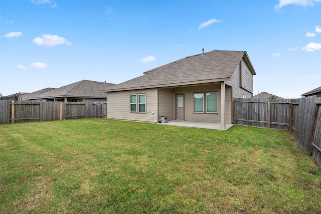 rear view of house featuring a patio and a yard