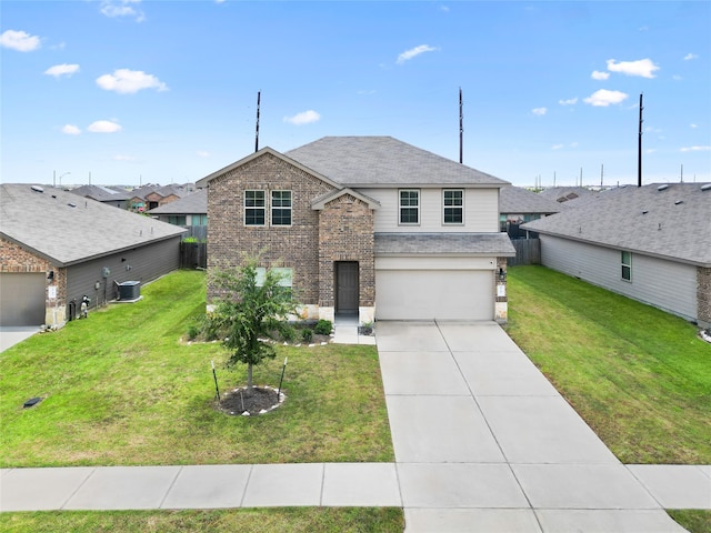 view of front facade featuring a garage, a front lawn, and central AC unit