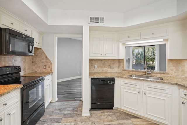 kitchen with white cabinetry, black appliances, sink, and decorative backsplash