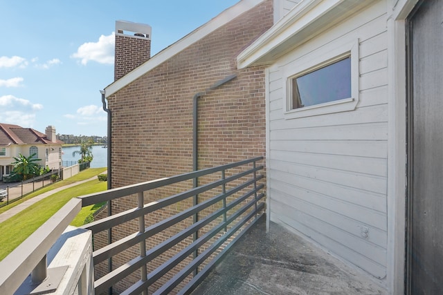 view of side of home featuring a water view and a balcony