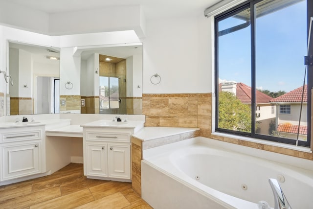 bathroom with vanity, plus walk in shower, and plenty of natural light