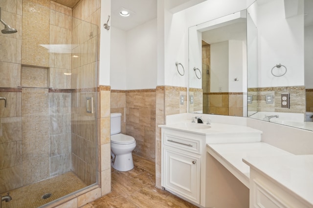 bathroom featuring hardwood / wood-style flooring, tile walls, toilet, a shower with shower door, and vanity