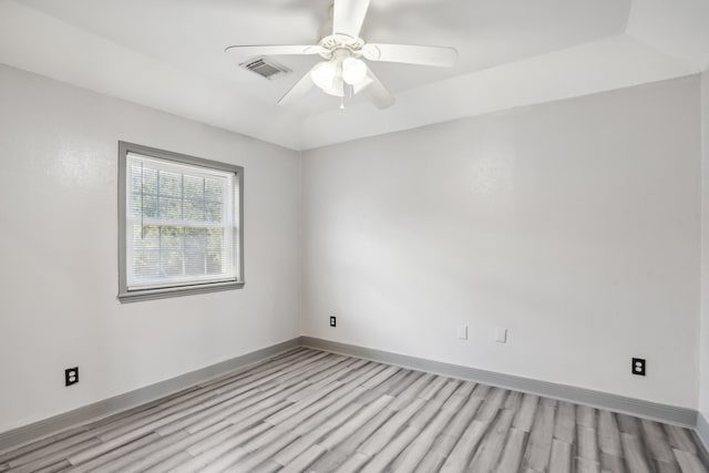 empty room featuring ceiling fan and light hardwood / wood-style flooring