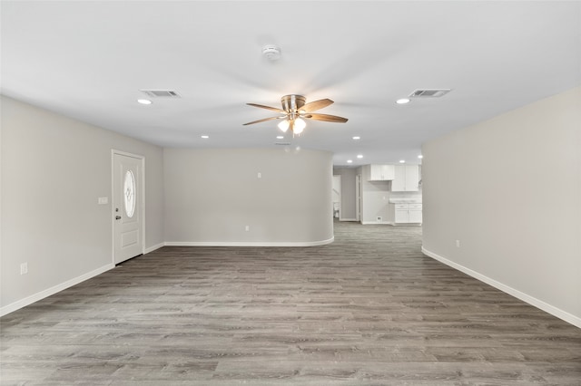 unfurnished living room featuring light hardwood / wood-style floors and ceiling fan