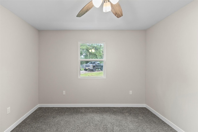 carpeted empty room featuring a ceiling fan and baseboards