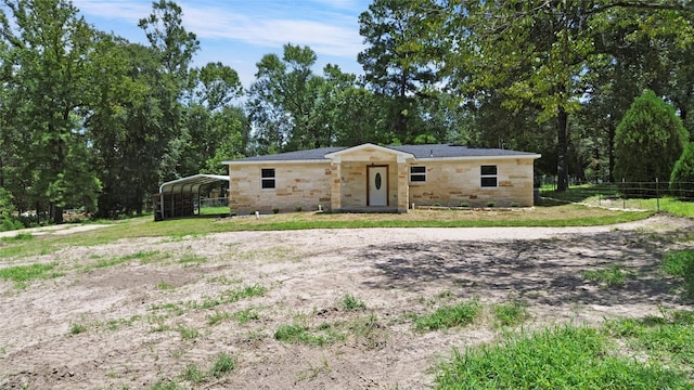 ranch-style house with a carport and a front lawn