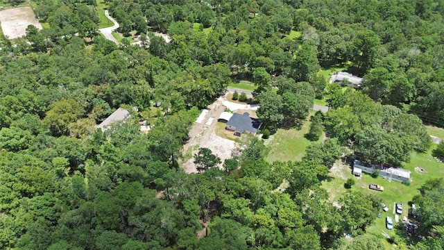 birds eye view of property featuring a wooded view