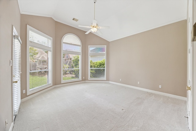 carpeted empty room featuring lofted ceiling, ornamental molding, and ceiling fan