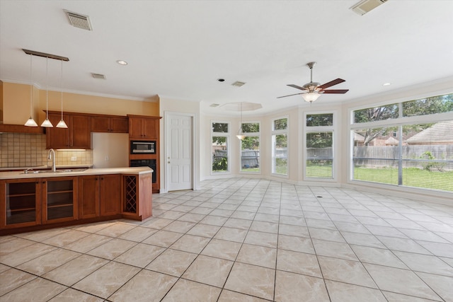 kitchen featuring stainless steel microwave, backsplash, ceiling fan, light tile patterned floors, and sink