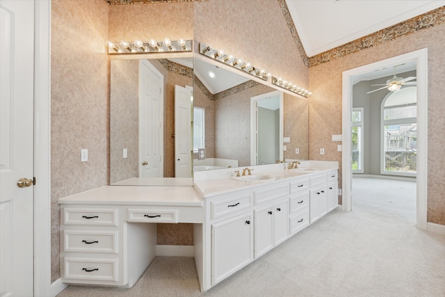 bathroom featuring ceiling fan, vanity, and vaulted ceiling