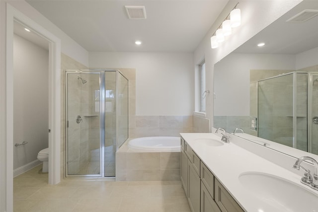 full bathroom featuring shower with separate bathtub, vanity, tile patterned floors, and toilet