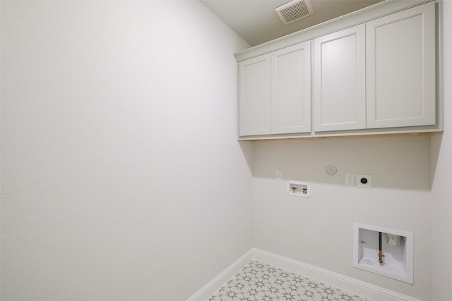 clothes washing area featuring hookup for a gas dryer, hookup for a washing machine, cabinets, and hookup for an electric dryer