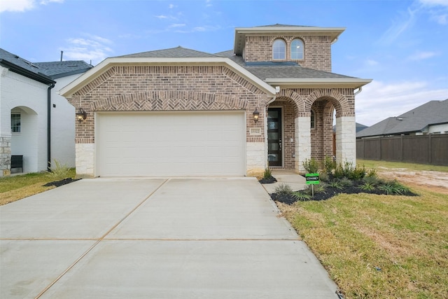 view of front facade with a front yard and a garage