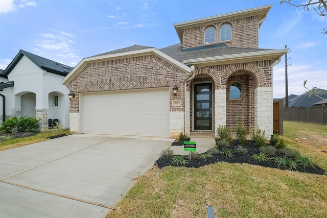 view of front of home featuring a front lawn and a garage