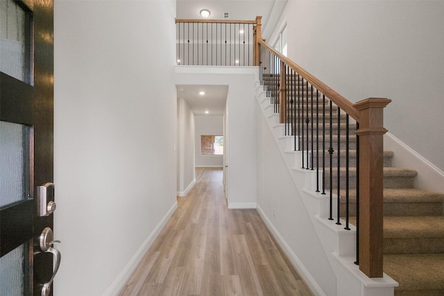 entrance foyer featuring a high ceiling and light hardwood / wood-style flooring