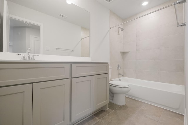 full bathroom with toilet, tiled shower / bath, and vanity