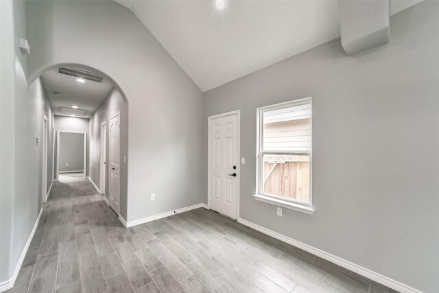 entrance foyer featuring lofted ceiling and light wood-type flooring