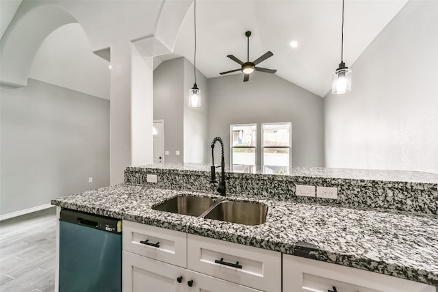 kitchen with dishwasher, white cabinetry, sink, and dark stone counters