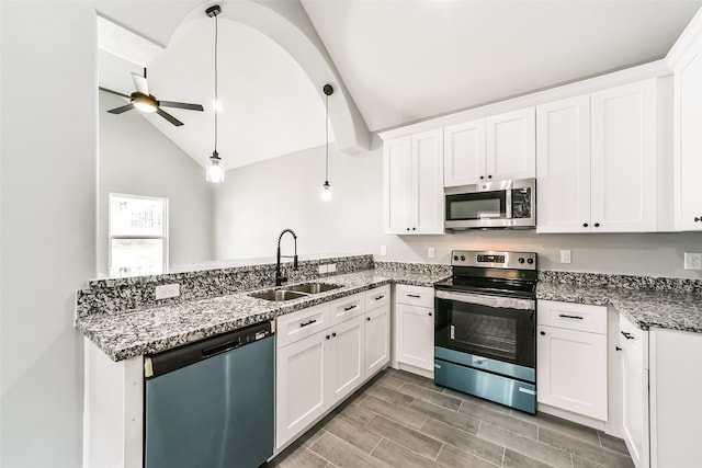 kitchen with pendant lighting, sink, ceiling fan, appliances with stainless steel finishes, and white cabinetry