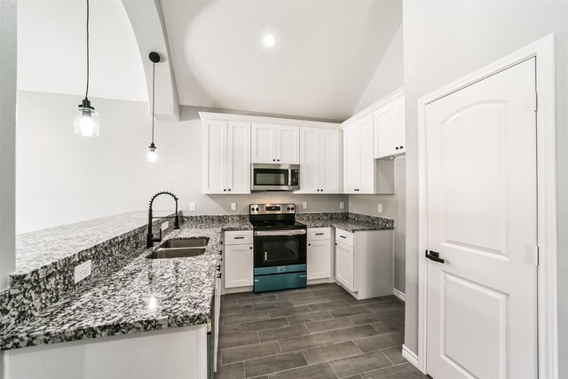 kitchen with sink, kitchen peninsula, pendant lighting, white cabinets, and appliances with stainless steel finishes