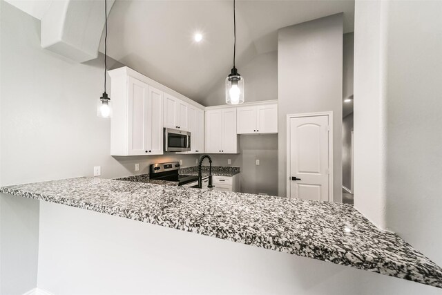 kitchen featuring white cabinets, pendant lighting, stainless steel appliances, and kitchen peninsula