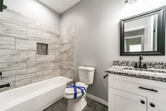 full bathroom with vanity, toilet, and tiled shower / bath combo