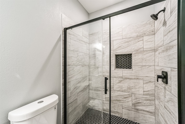 bathroom with toilet and an enclosed shower