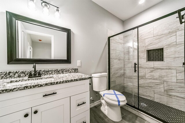 bathroom with vanity, toilet, and walk in shower