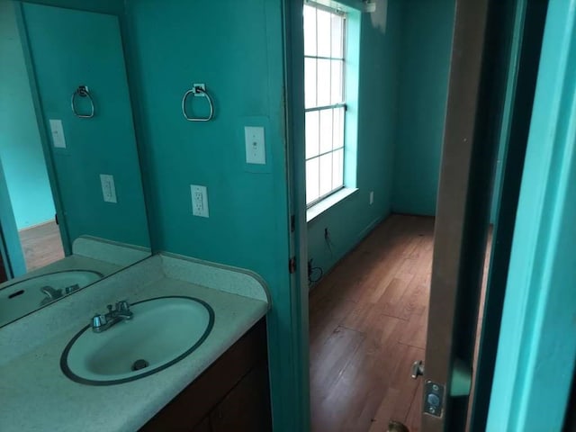 bathroom featuring hardwood / wood-style flooring, vanity, and plenty of natural light