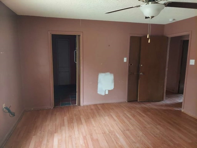 unfurnished room featuring ceiling fan and light hardwood / wood-style floors