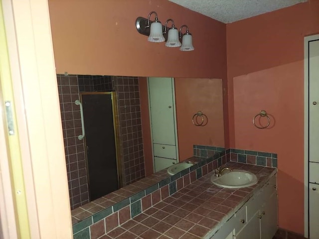 bathroom with vanity and tiled shower