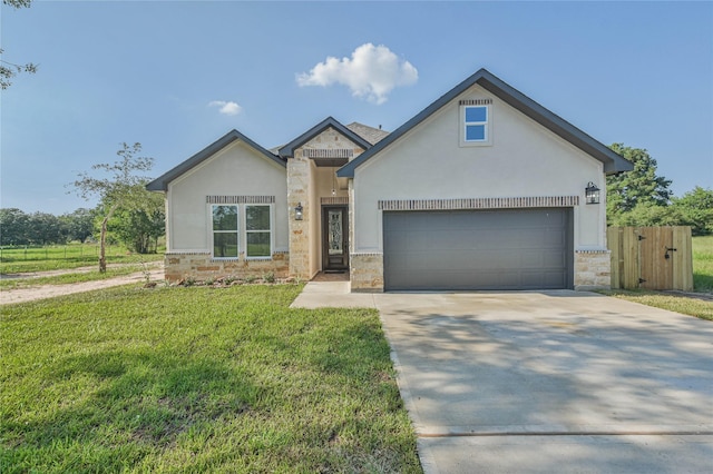 view of front of house featuring a garage and a front lawn