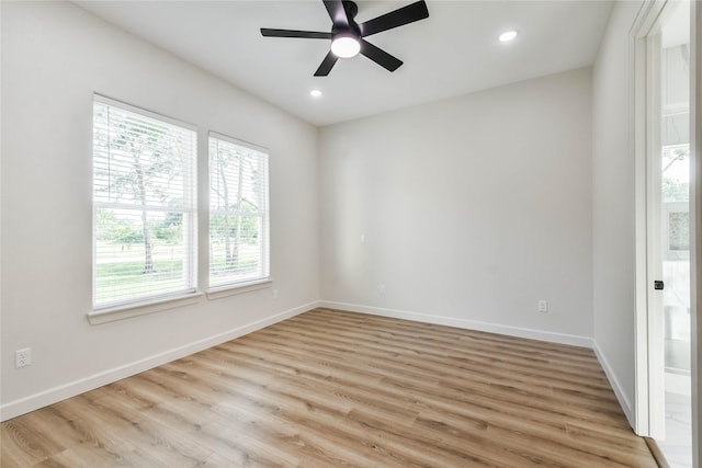 empty room featuring ceiling fan and light hardwood / wood-style floors