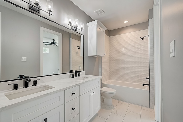 full bathroom with vanity, ceiling fan, tiled shower / bath, and toilet