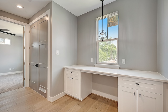 kitchen featuring ceiling fan, pendant lighting, light hardwood / wood-style flooring, and white cabinets