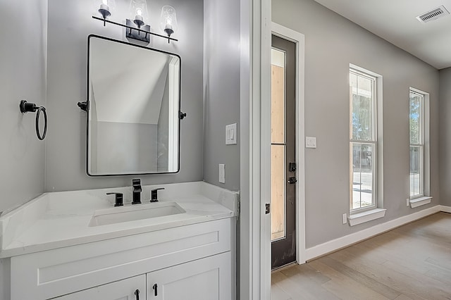 bathroom with vanity and hardwood / wood-style flooring