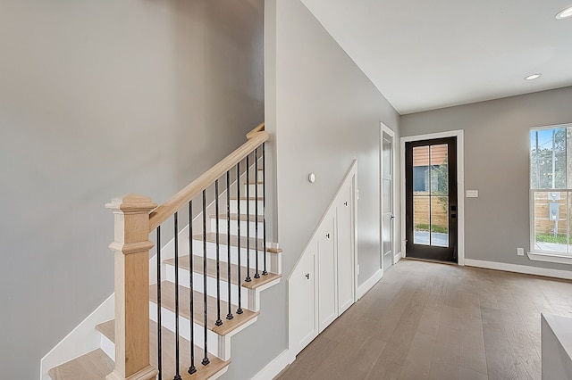 stairs featuring hardwood / wood-style flooring