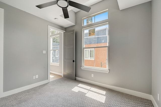 spare room featuring light carpet and ceiling fan