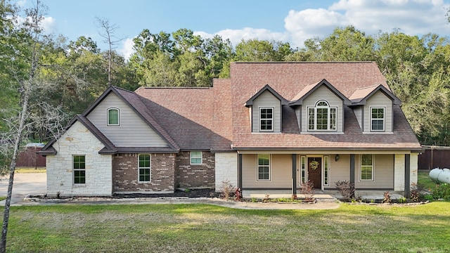 view of front of home with a porch and a front lawn