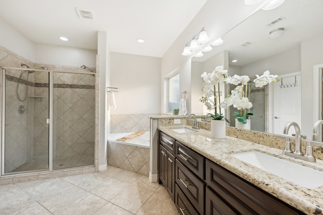 bathroom with dual vanity, plus walk in shower, and tile patterned flooring