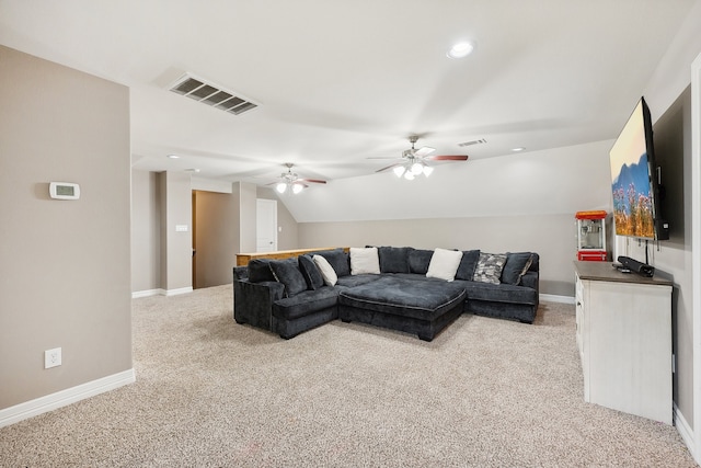 carpeted living room with ceiling fan and lofted ceiling