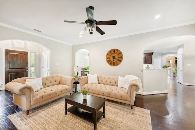 living room featuring ornamental molding, hardwood / wood-style floors, and ceiling fan