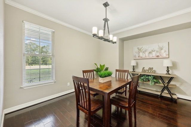 dining room with crown molding, dark hardwood / wood-style flooring, and an inviting chandelier