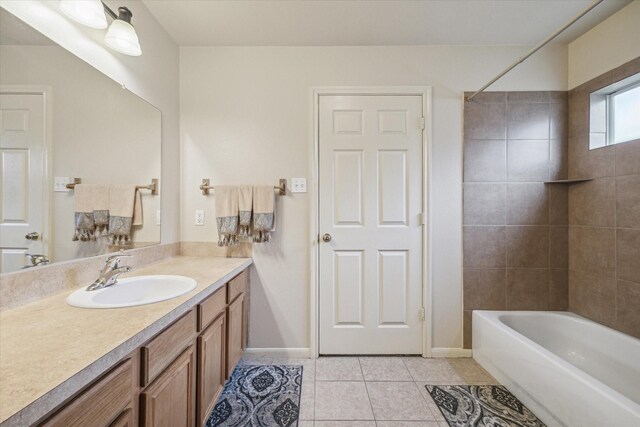 bathroom featuring tiled shower / bath combo, vanity, and tile patterned flooring