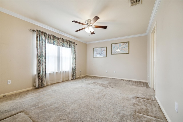 carpeted spare room with ceiling fan and ornamental molding