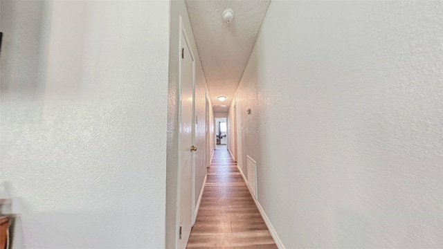 hallway featuring wood-type flooring