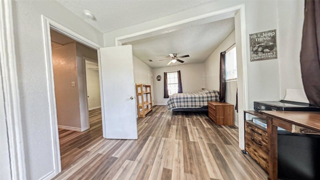 bedroom featuring ceiling fan, a textured ceiling, and hardwood / wood-style floors