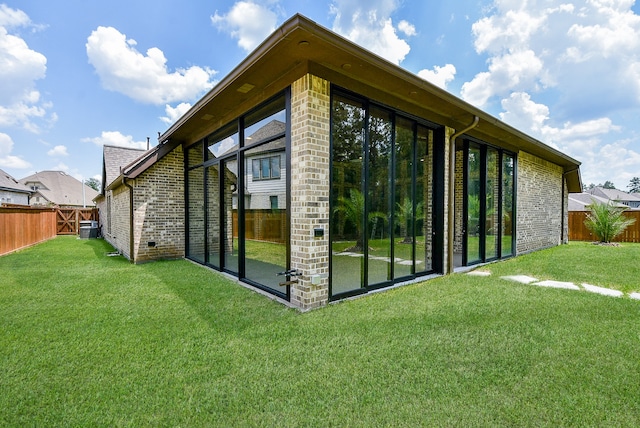 back of house featuring a lawn